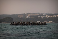 U.S. Marines with Battalion Landing Team 2/4, 31st Marine Expeditionary Unit, prepare to insert during a simulated boat raid on Recon Beach, Camp Schwab, Okinawa, Japan, Feb. 17, 2025