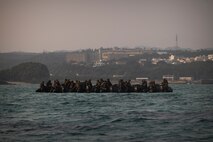 U.S. Marines with Battalion Landing Team 2/4, 31st Marine Expeditionary Unit, prepare to insert during a simulated boat raid on Recon Beach, Camp Schwab, Okinawa, Japan, Feb. 17, 2025