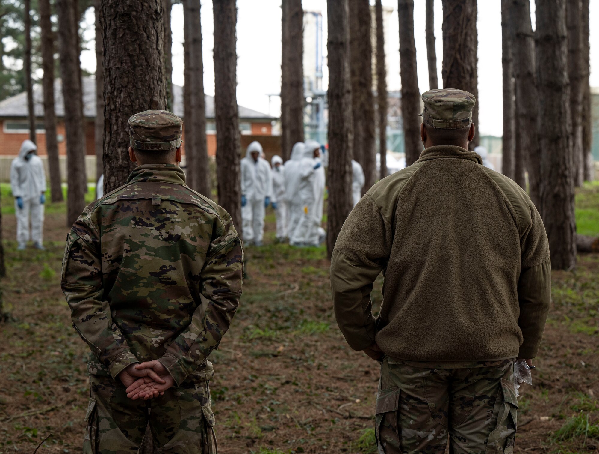 U.S. Air Force Capt. Carlos J. Rivera, left, 100th Force Support Squadron sustainment services flight commander, and Senior Master Sgt. Demarcus Hunt, 100th Force Support Squadron sustainment services superintendent, supervise Airmen as they conduct search and recovery training at RAF Mildenhall, England, Feb. 21, 2025.