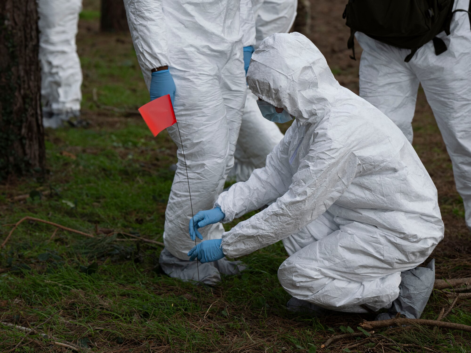 A U.S. Airman assigned to the 100th Force Support Squadron plants a marker into the ground to indicate important material during search and recovery training at RAF Mildenhall, England, Feb. 21, 2025.