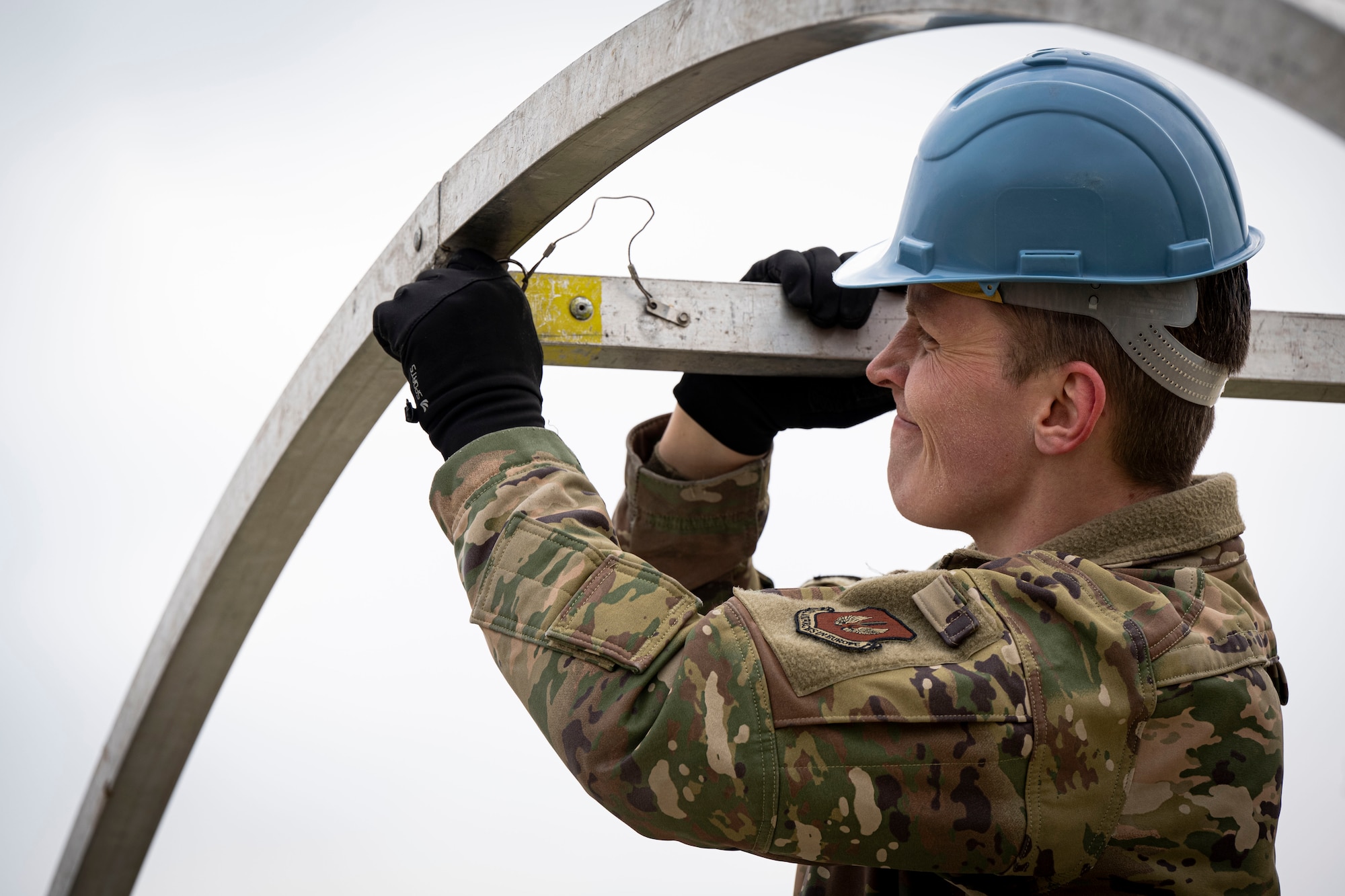U.S Air Force Senior Airman Nicholas Gerling, 100th Force Support Squadron sports director, assembles a portable shelter during contingency and proficiency readiness training at RAF Mildenhall, England, Feb. 13, 2025.