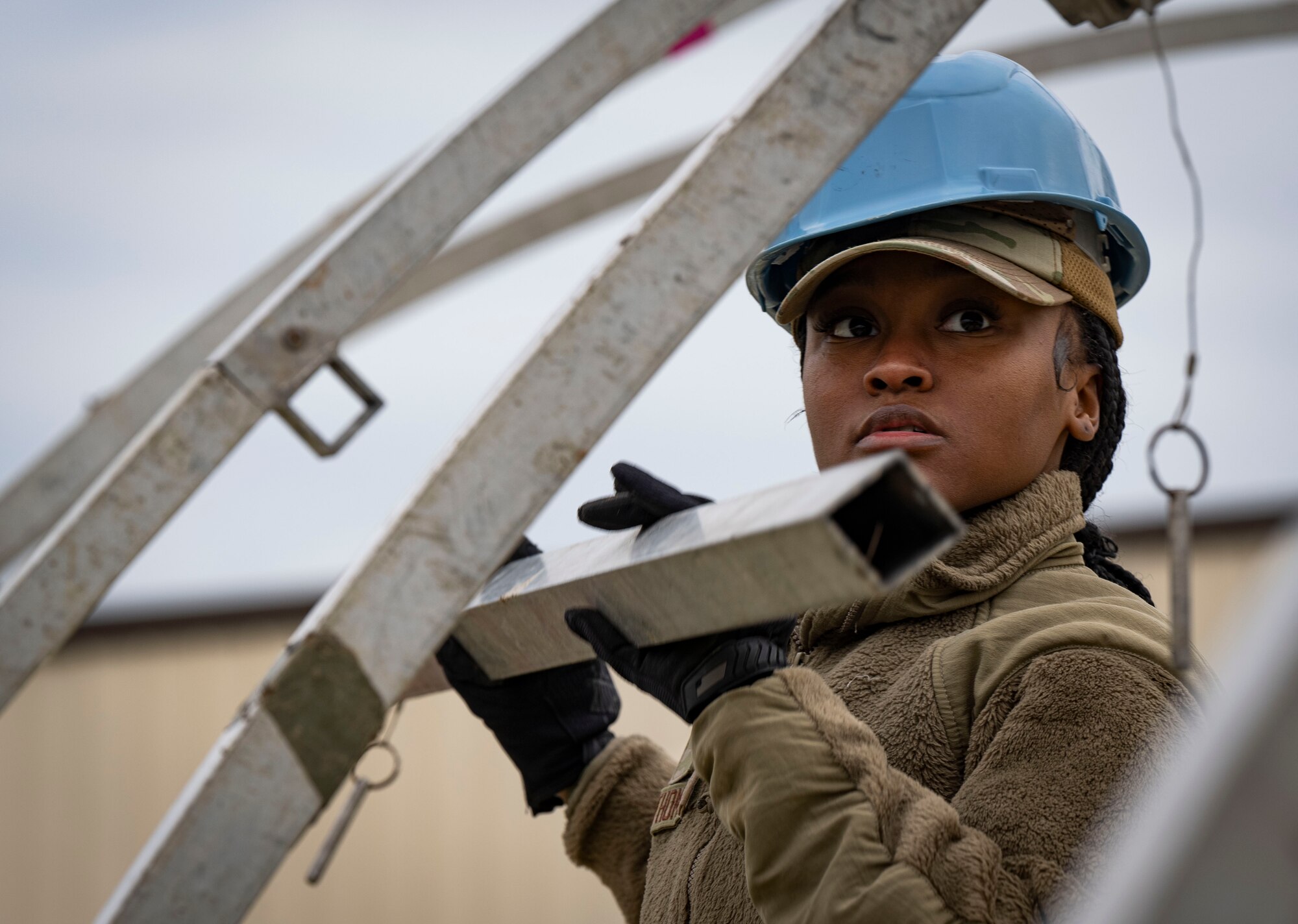 U.S Air Force Airman Denyia Thomas, 100th Force Support Squadron fitness center specialist, assembles a portable shelter during contingency and proficiency readiness training at RAF Mildenhall, England, Feb. 13, 2025.