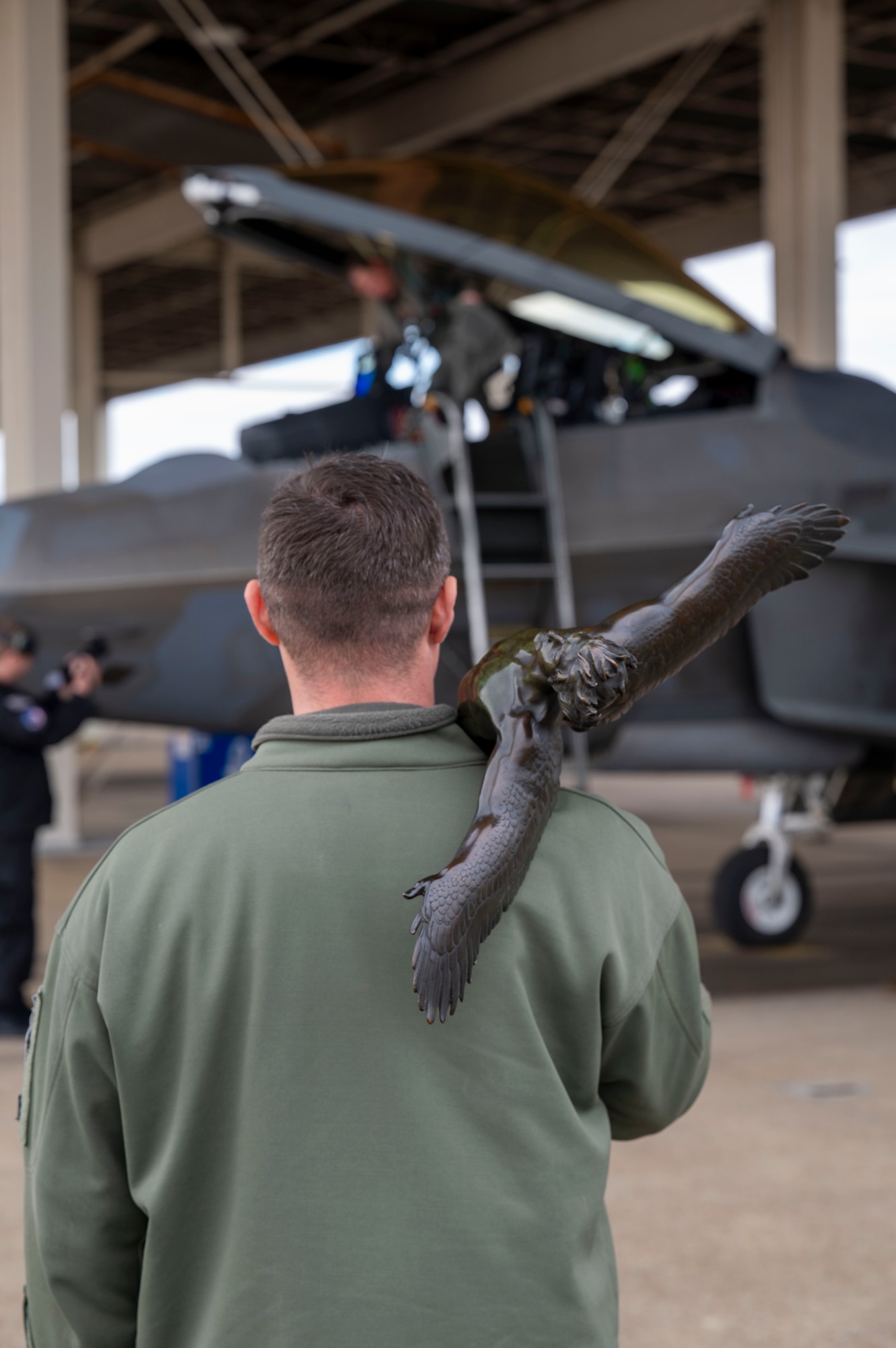 LANGLEY AIR FORCE BASE, Va. – U.S. Air Force Col. Brandon Tellez, 1st Fighter Wing commander, waits for Lt. Col. Devil 94th Fighter Squadron commander, to exit his F-22 Raptor after being the first competitor to complete his task during the Mitchell Trophy Air Race  at Langley Air Force Base, Virginia,  Mar. 7, 2025. The 1st FW exclusive rACE involved a 446 nautical mile flight from Langley AFB to Selfridge Air National Guard Base, Michigan and then back after completing various ACE task performed by the pilots at Selfridge. (U.S. Air Force photo by Tech. Sgt. Matthew Coleman-Foster)