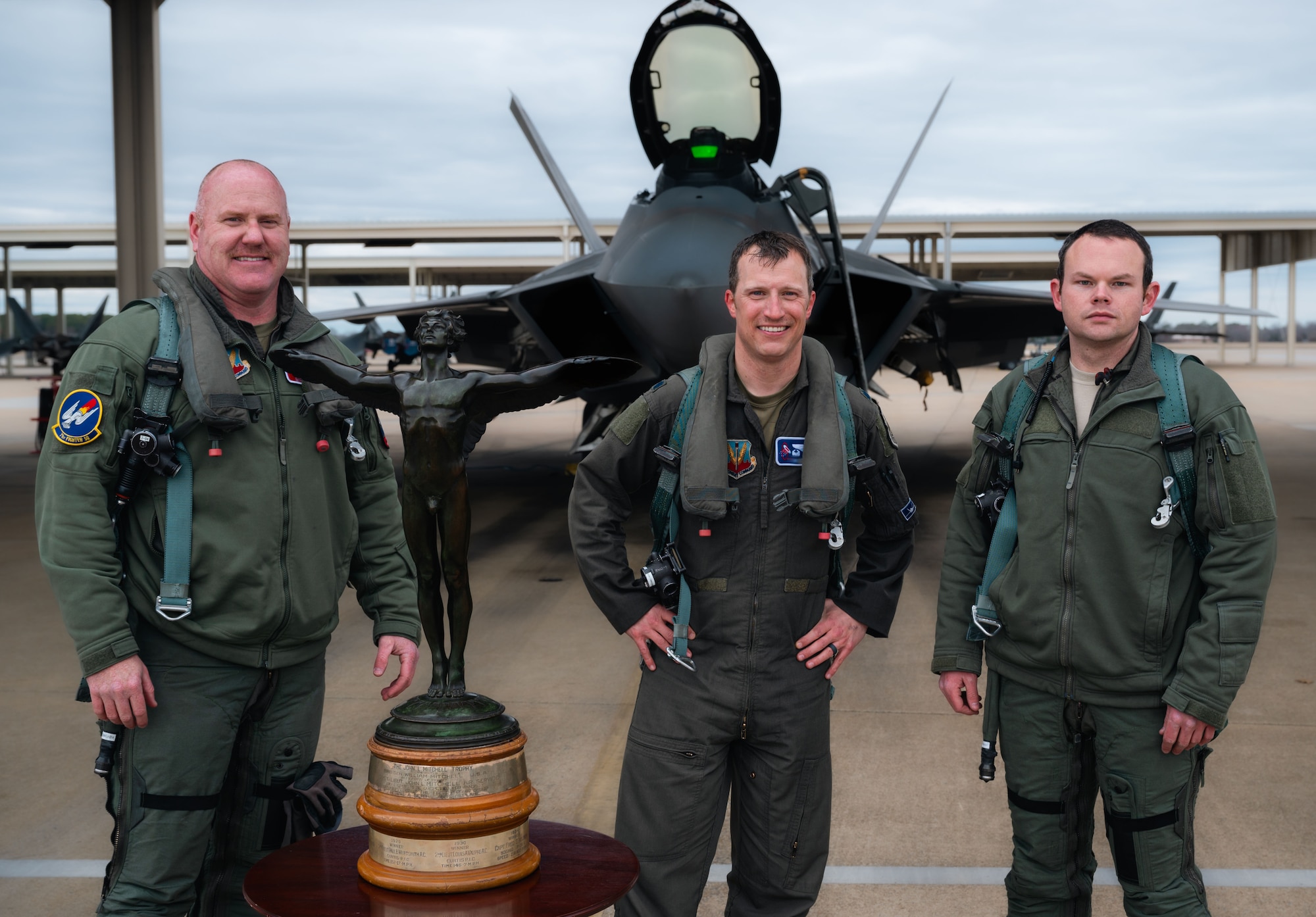 From the left, U.S. Air Force Col. “Lite”, 71st Fighter Squadron commander, Lt. Col. “Devil”, 94th Fighter Squadron commander, and Capt. “Marbro”, 27th Fighter Squadron pilot, pose for a group photo after competing in the Mitchell Trophy Air Race at Langley Air Force Base, Virginia, Mar. 6, 2025. The Mitchell Trophy Air Race was a historic test of skill and strategy, pushing early Airmen to their limits nearly a century ago. Its revival showcased how competition fuels readiness, and challenged a new generation of pilots to sharpen their skills and enhance operational effectiveness. (U.S. Air Force photo by Senior Airman Mikaela Smith)