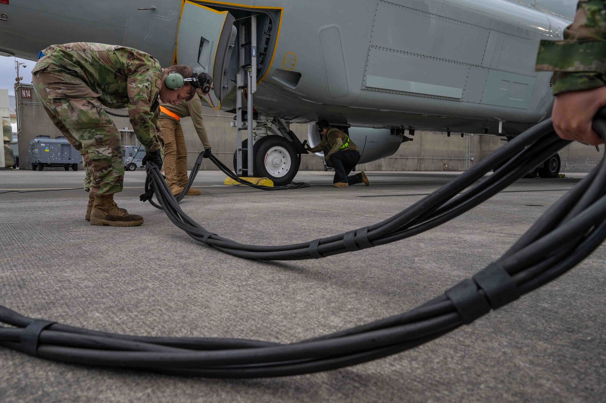 Airman removing an external power cord from an RC-135