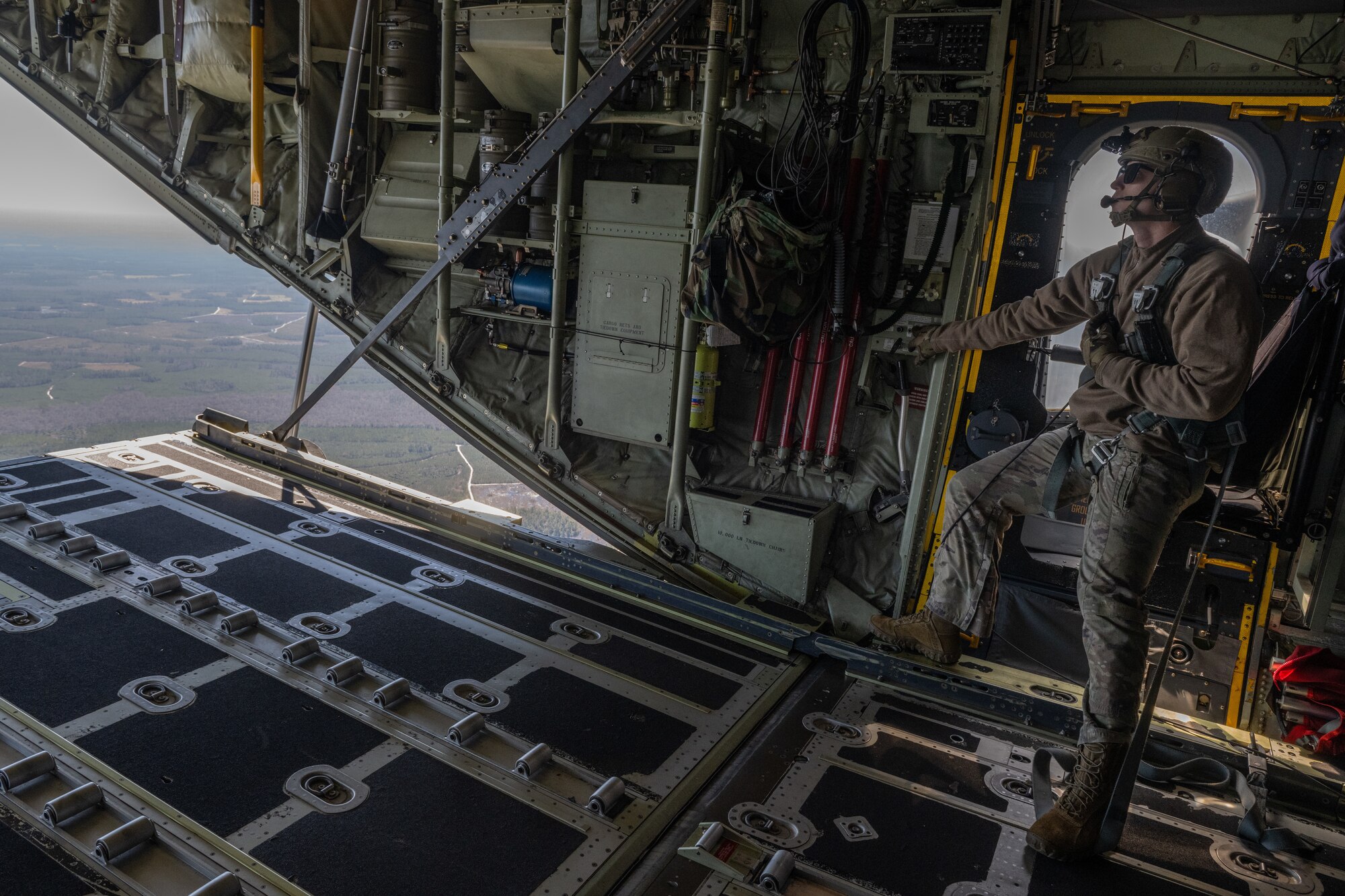 A loadmaster lowers the ramp on a HC-130J Combat King II.