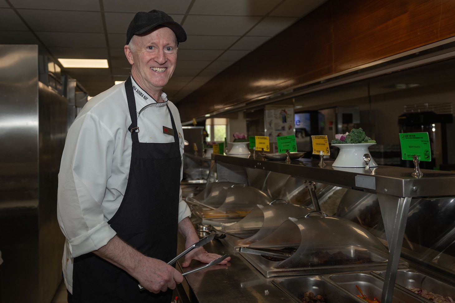 Watch Captain Allen Greer, assigned to Naval Support Activity Souda Bay’s Minoan Taverna, serves food on the serving line in the Minoan Taverna onboard NSA Souda Bay on March 11, 2025.