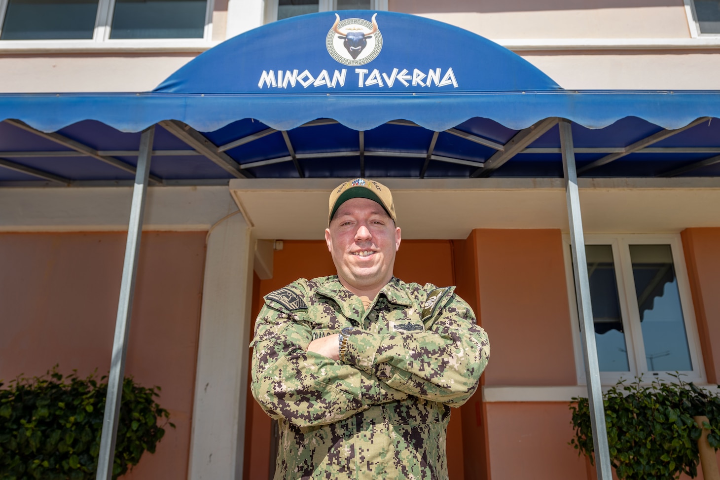 Chief Warrant Officer 3 Jeremy Domagalski, Naval Support Activity Souda Bay food service officer, welcomes Sailors into the Minoan Taverna onboard NSA Souda Bay on March 11, 2025.