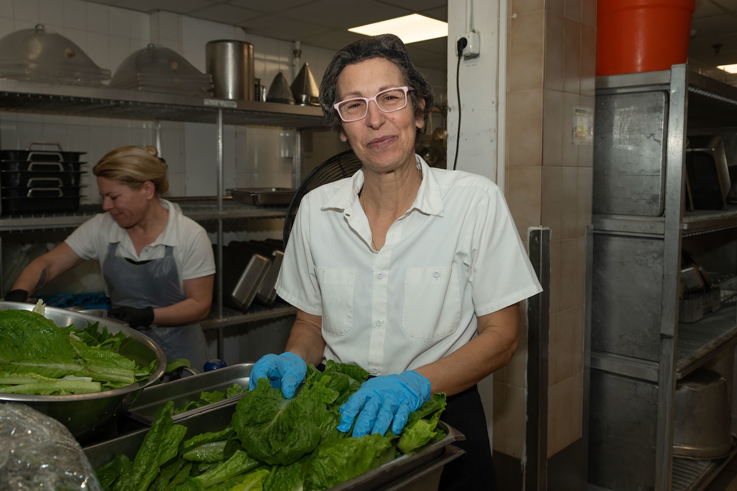 Food Service Attendant Maria Kolormaki, assigned to Naval Support Activity Souda Bay’s Minoan Taverna, prepares lettuce in the Minoan Taverna onboard NSA Souda Bay on March 11, 2025.