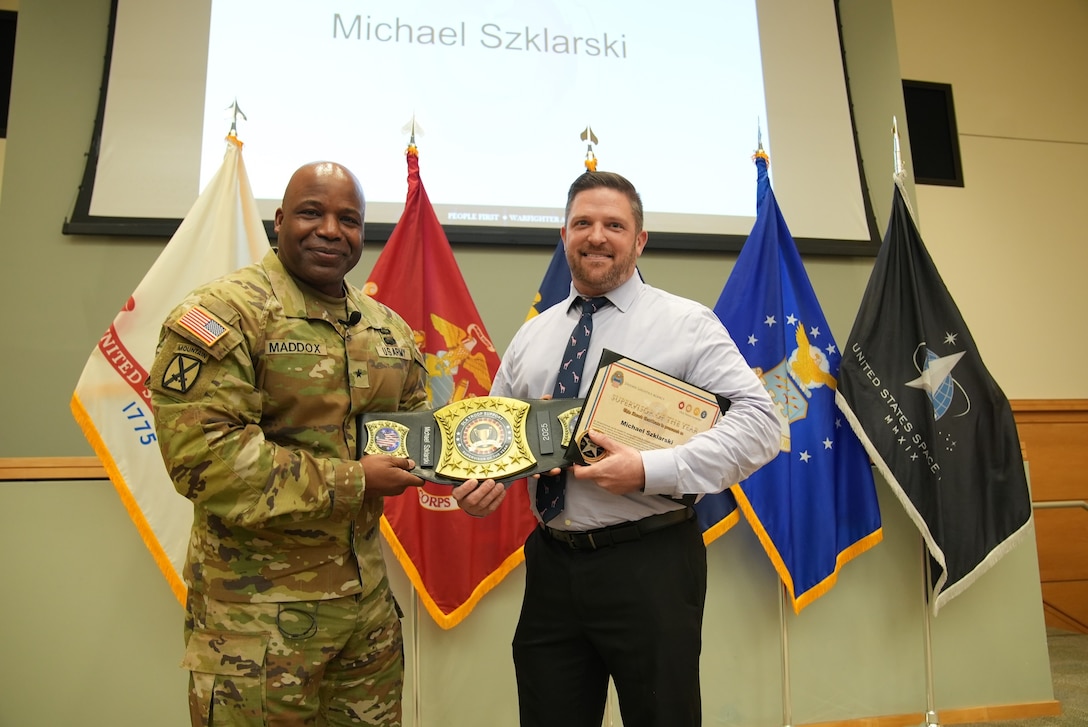 Troop Support Commander Army Brig. Gen. Landis Maddox presents Michael Szklarski, Supervisor of the Year, with his awards on March 11. (Photo taken by: Ed Maldonado)