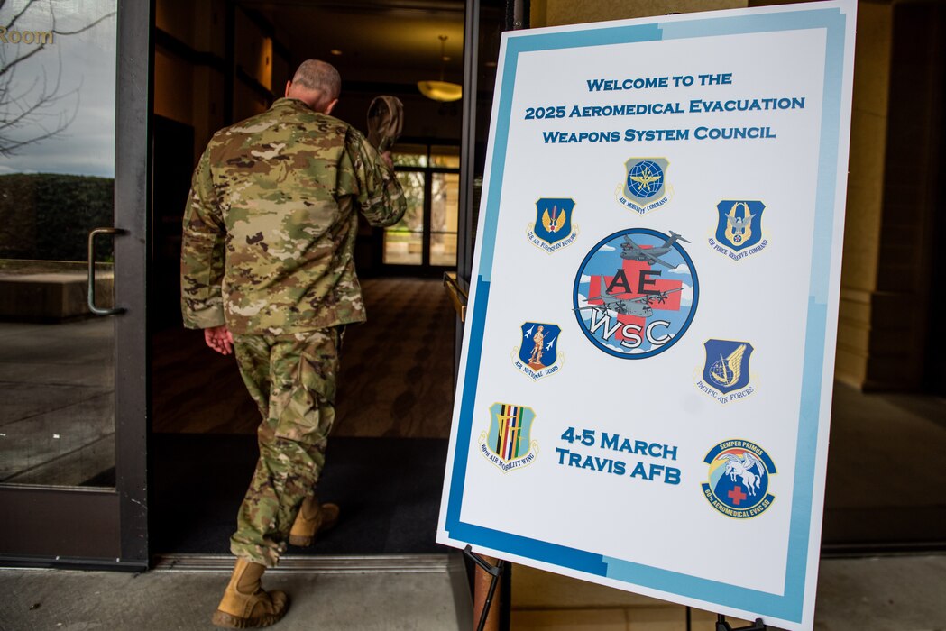 An Airman walks in to an Aeromedical Evacuation Weapons Systems council.