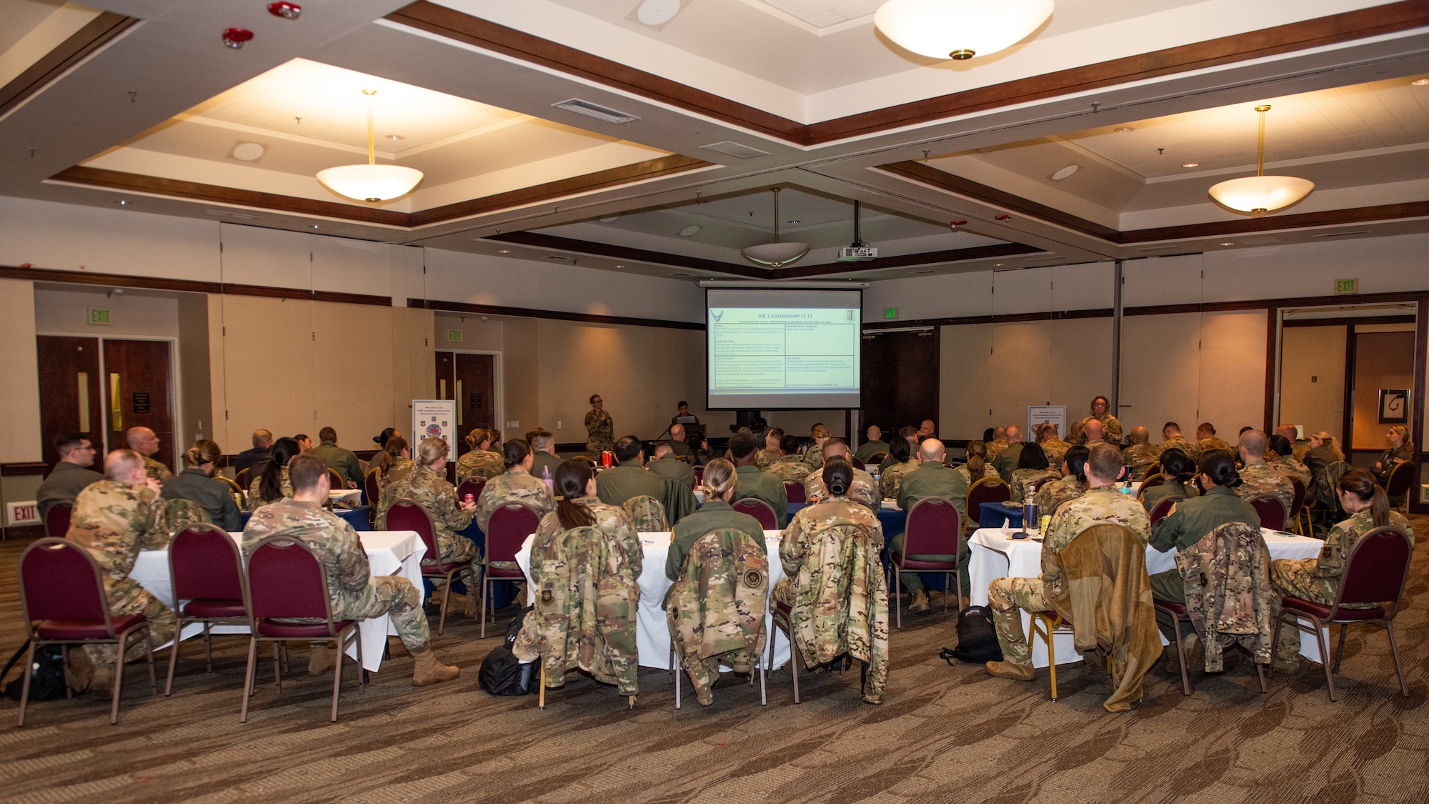 Conference attendees listen to a briefing