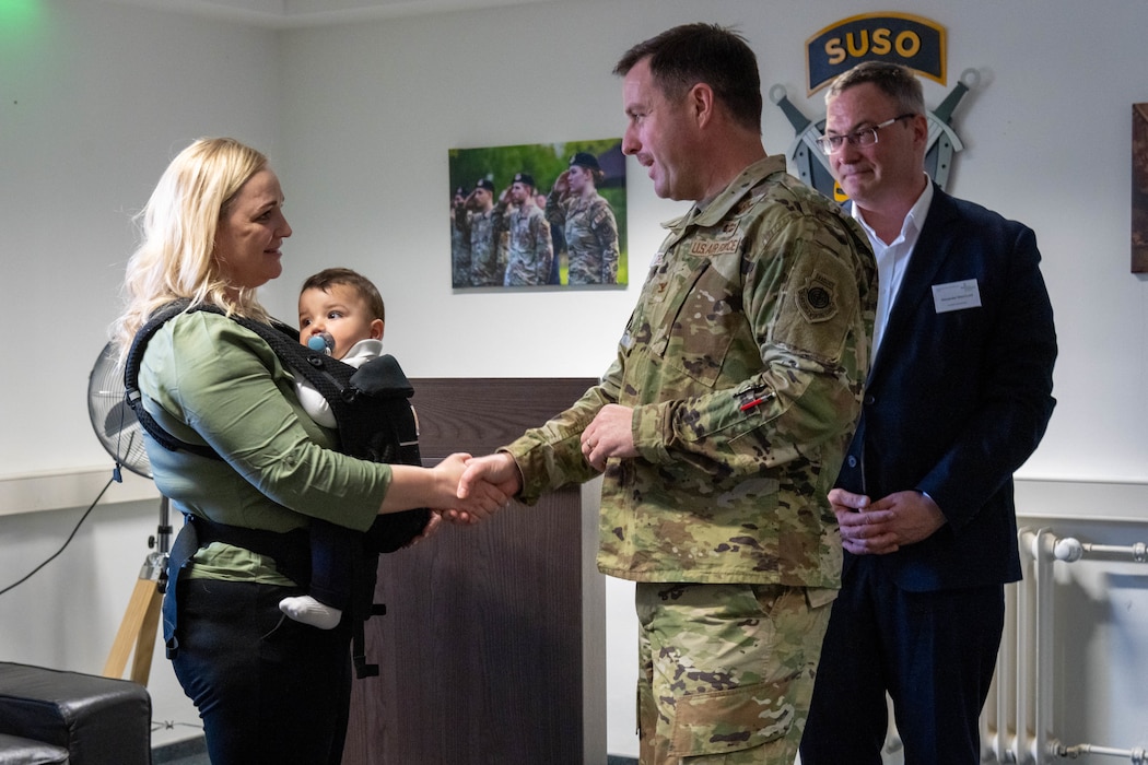 Col. Kevin Crofton, 52nd Fighter Wing commander, right of the photo, presents a coin to ZP-4 Sabrina Figueroa, 52nd Security Forces patrolman, left of the photo.