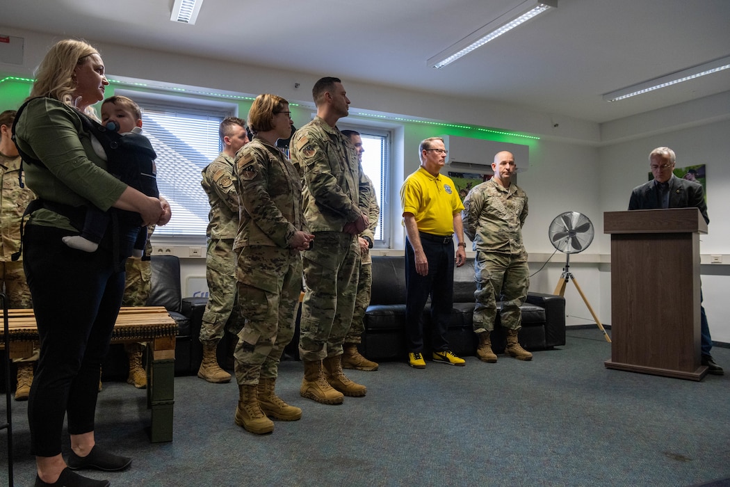 A group of service members gather during a recognition ceremony.