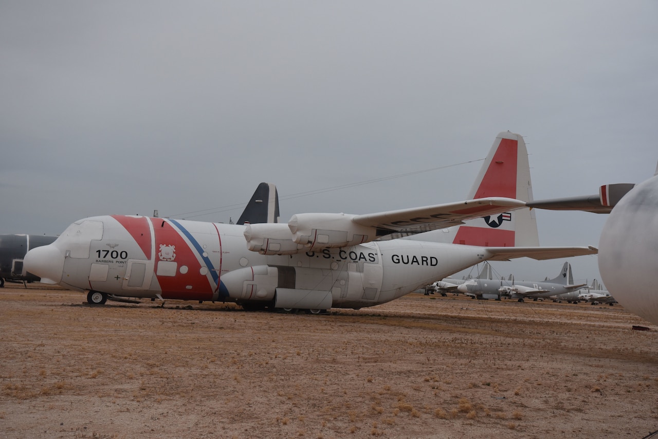 An airplane is parked in the desert.