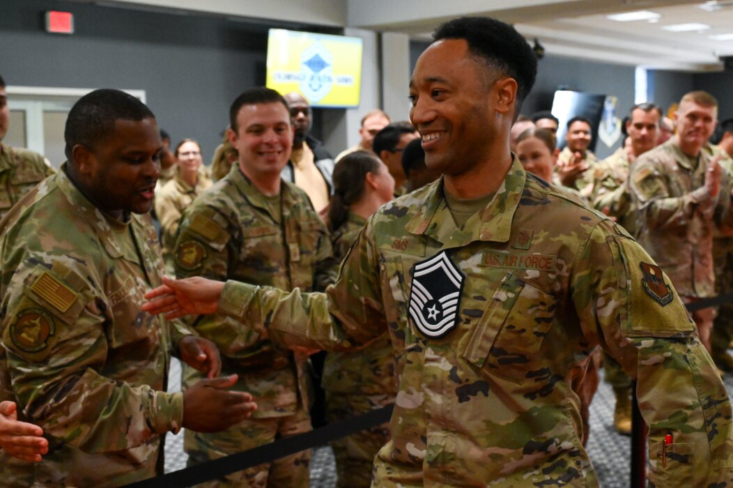 U.S. Air Force Senior Master Sgt. select Justin Sims, 17th Healthcare Operations Squadron, walks the red carpet as he is cheered on by military personnel and friends from the 17th Training Wing as part of the Senior Master Sergeant Release Party at the Powell Event Center, Goodfellow Air Force Base, Texas, March 10, 2025.  The selectees were honored with a celebratory red carpet walk and cheered on by family members, friends and fellow 17th TRW Raiders. (U.S. Air Force photo by Airman 1st Class James Salellas)