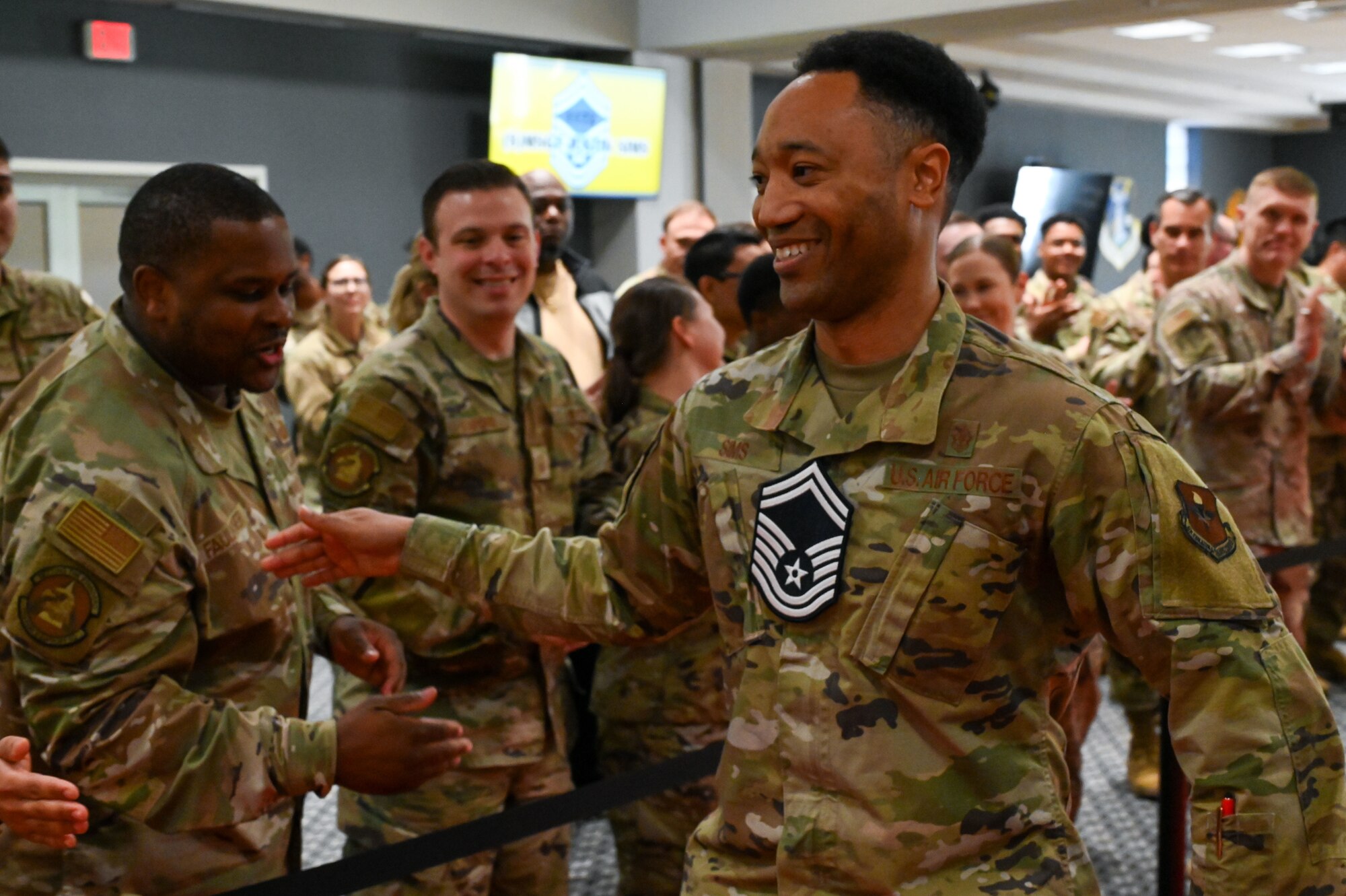 U.S. Air Force Senior Master Sgt. select Justin Sims, 17th Healthcare Operations Squadron, walks the red carpet as he is cheered on by military personnel and friends from the 17th Training Wing as part of the Senior Master Sergeant Release Party at the Powell Event Center, Goodfellow Air Force Base, Texas, March 10, 2025.  The selectees were honored with a celebratory red carpet walk and cheered on by family members, friends and fellow 17th TRW Raiders. (U.S. Air Force photo by Airman 1st Class James Salellas)