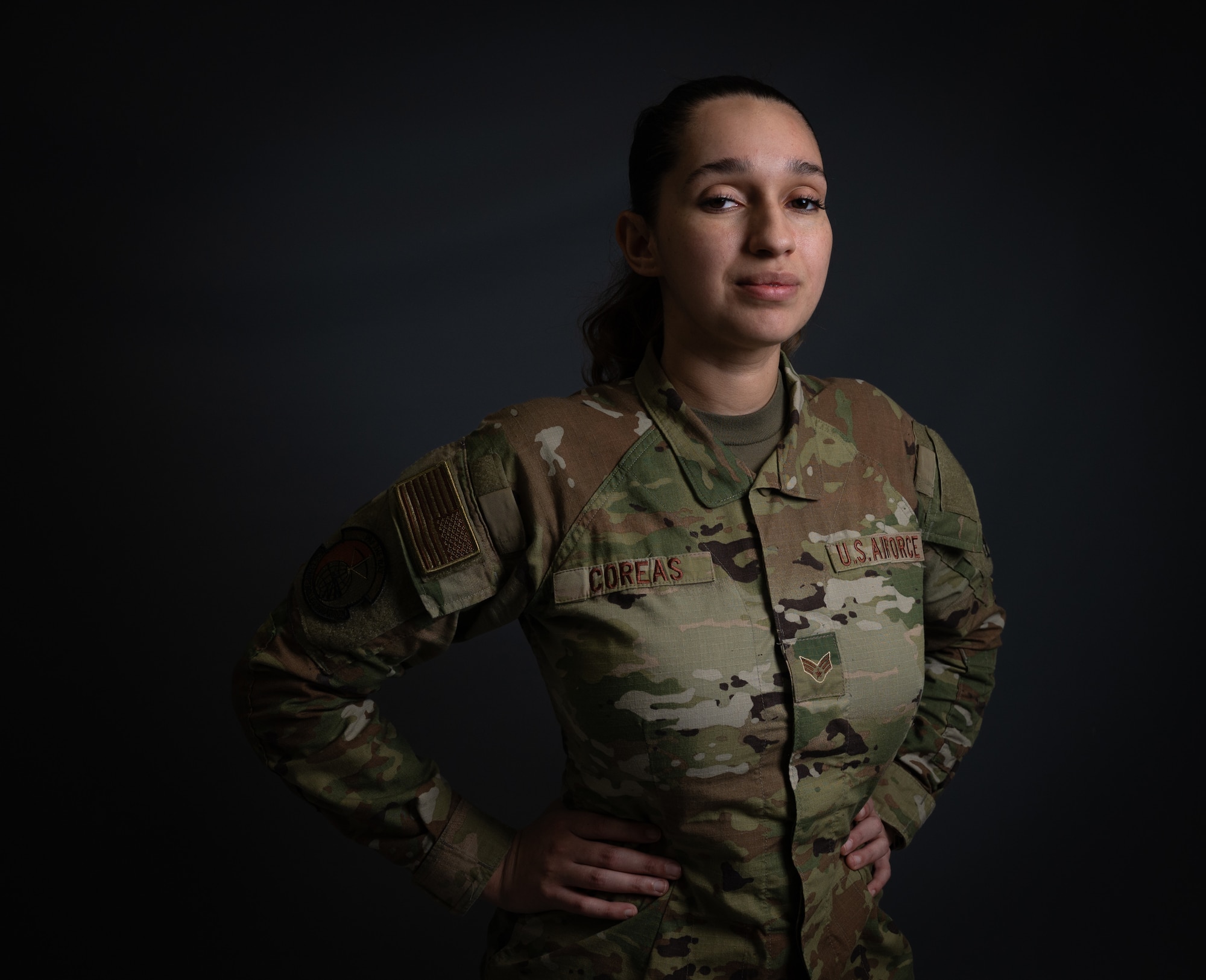 A woman in uniform stand for photo