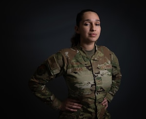 A woman in uniform stand for photo