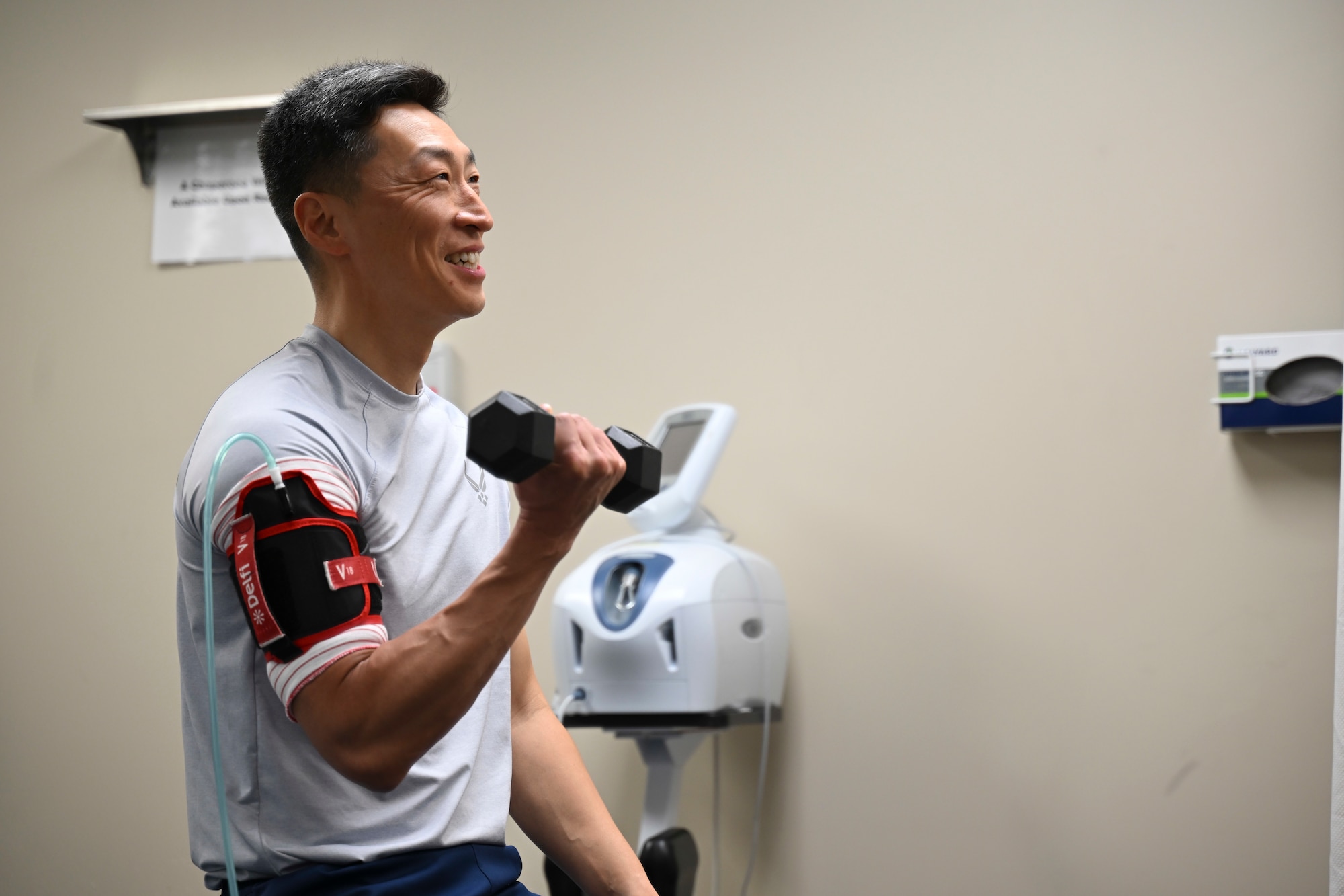 U.S. Air Force Col. Jun S. Oh, 316th Wing and installation commander, participates in a blood flow restriction training demonstration at the Physical Medicine Clinic on Joint Base Andrews, Md., Feb. 26, 2024. Senior Airman Mathilde French-Elliott, a physical medicine technician with the 316th Operational Medical Readiness Squadron, explained the training as part of the “Winnin’ Like a Griffin” initiative while guiding Oh through the process.