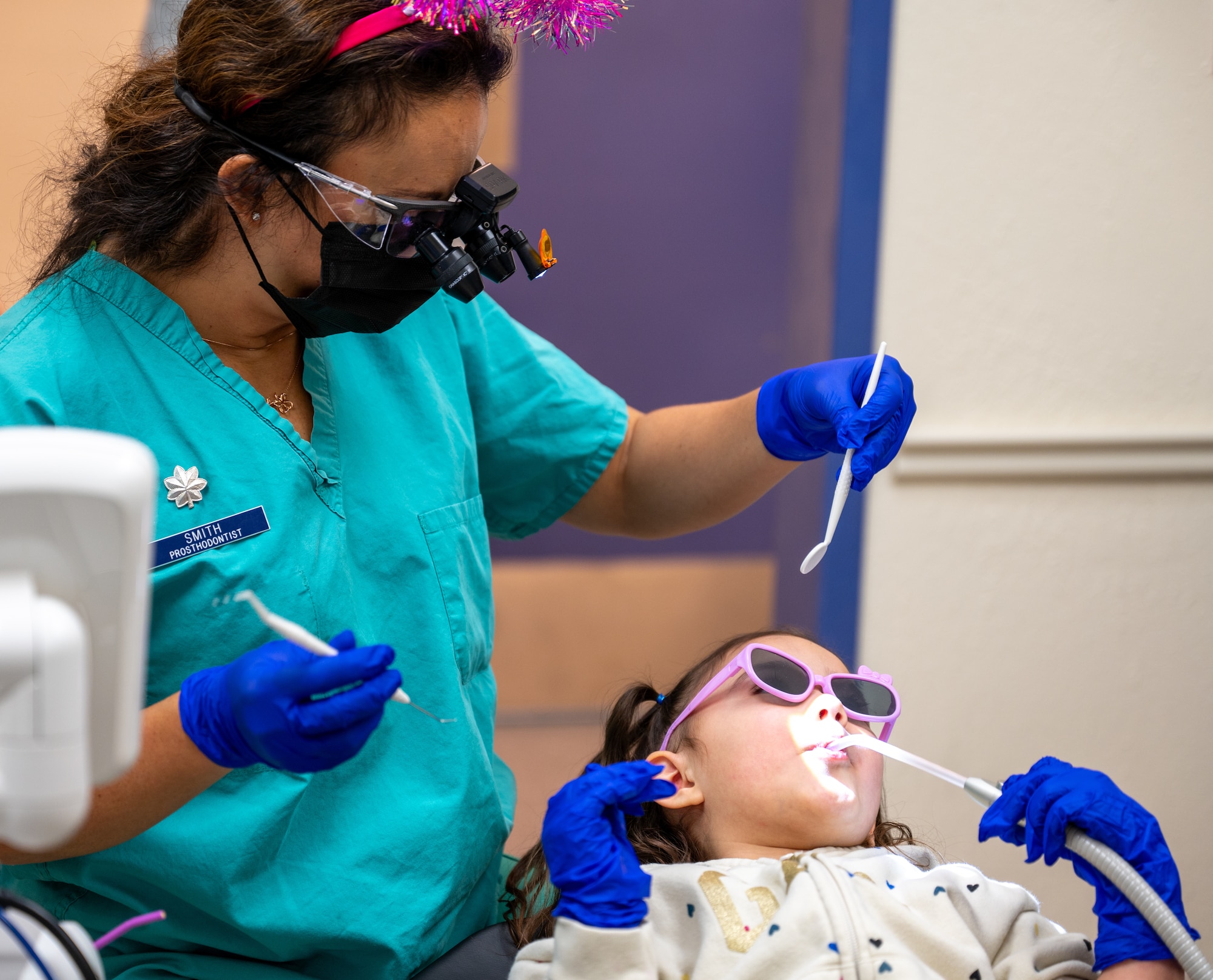 A child uses a suction device during a cleaning.