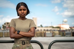 U.S. Air Force Airman Deborah Oluwafemi, an air transportation function apprentice assigned to the 6th Logistics Readiness Squadron, poses for a photo on the flight line.