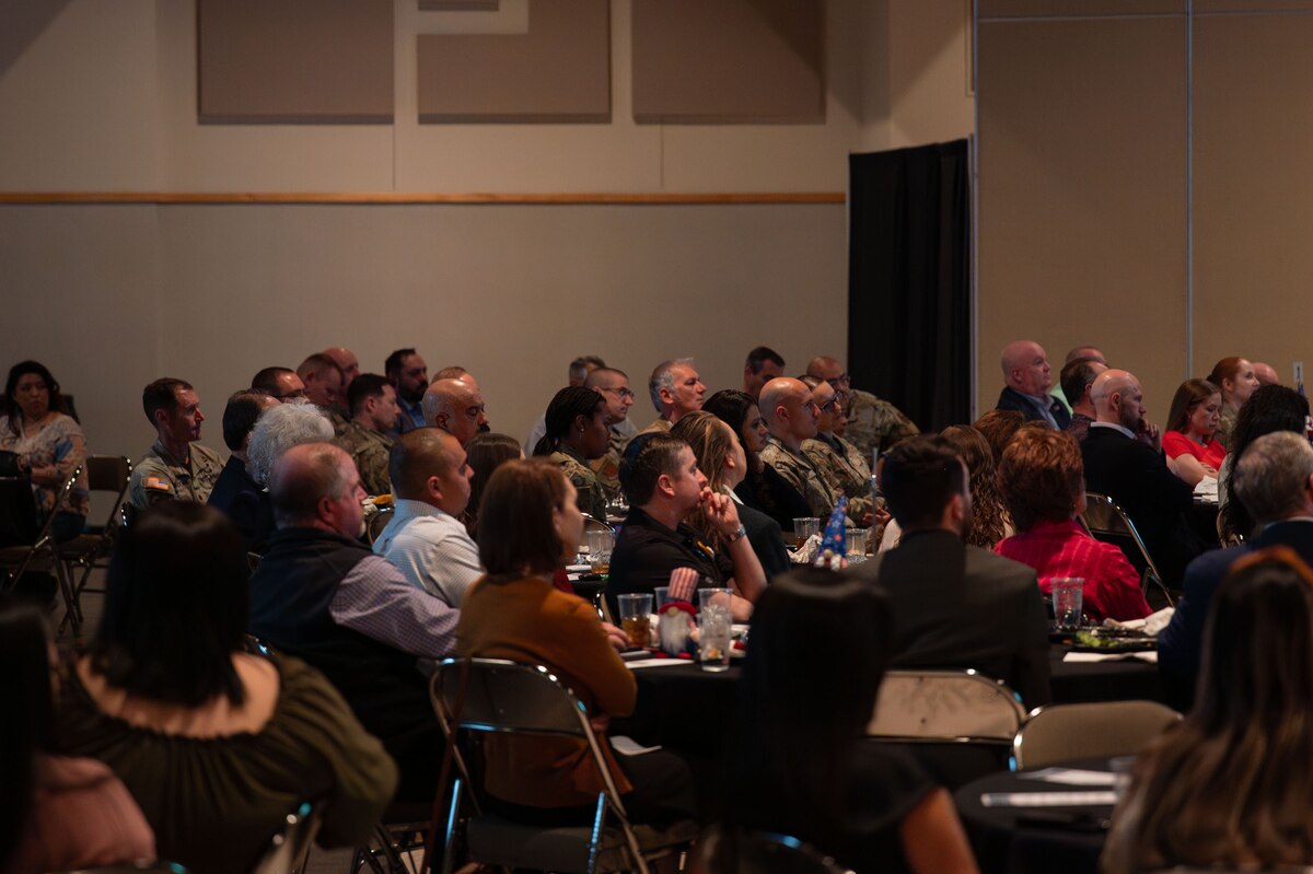 Attendees and members of the San Angelo Chamber of Commerce listen to U.S. Air Force Col. Angelina Maguinness, 17th Training Wing commander, give a speech during the San Angelo Chamber of Commerce State of Goodfellow Luncheon at the McNease Convention Center, San Angelo, Texas, March 11, 2025. The luncheon allowed attendees to hear updates from various San Angelo community members and 17th Training Wing representatives. (U.S. Air Force photo by Airman 1st Class Brian Lummus)