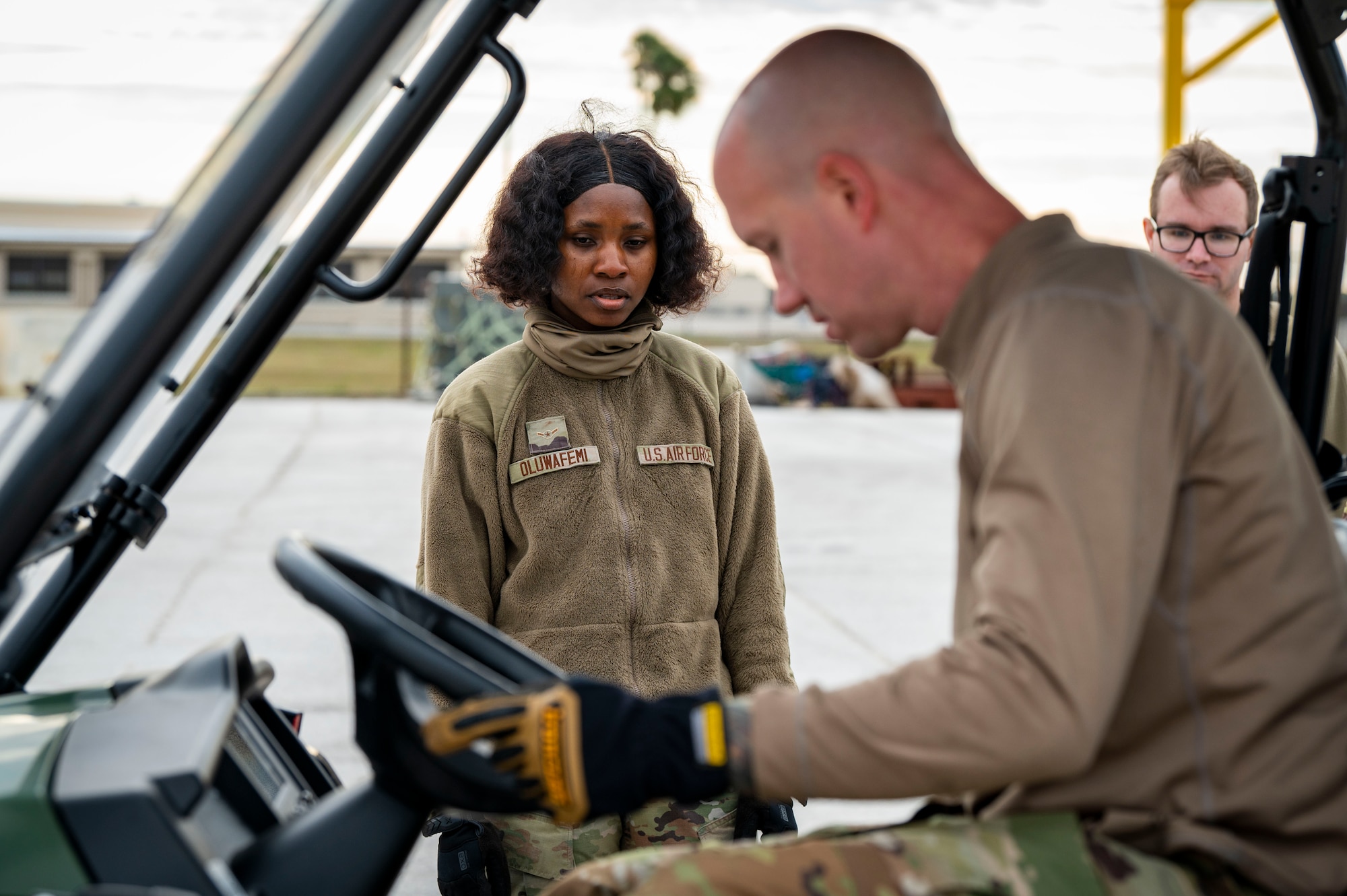 U.S. Air Force Airman Deborah Oluwafemi, an air transportation function apprentice assigned to the 6th Logistics Readiness Squadron, watches as Staff Sgt. Daryl Yansky, an aerospace ground equipment craftsman assigned to the 6th Maintenance Squadron, drives a vehicle onto portable vehicle scales during increment monitor training.