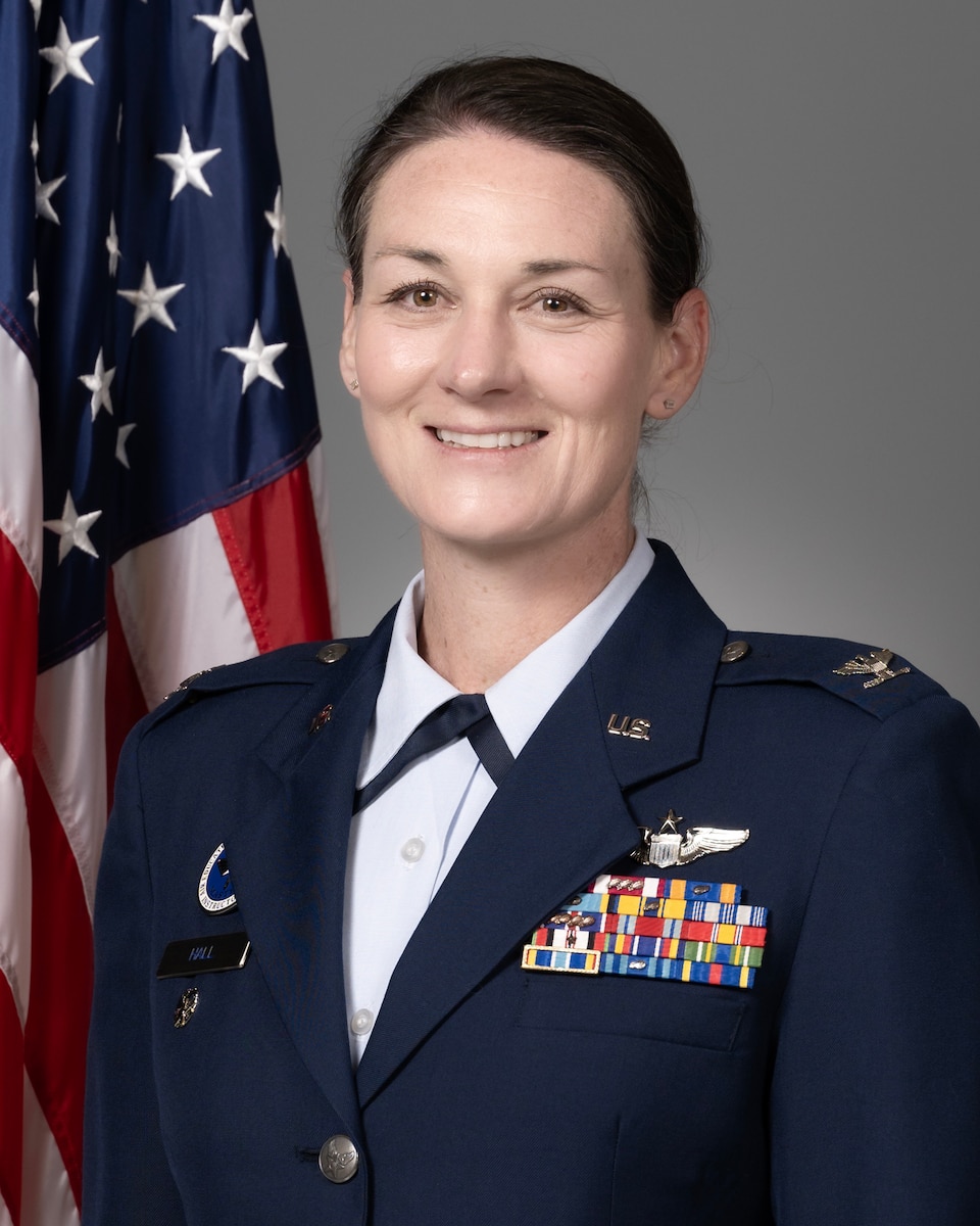 A studio photo of a servicewoman in formal United States Air Force attire.