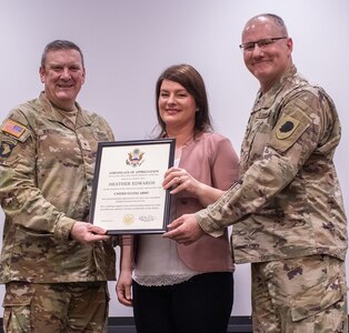 Brig. Gen. Lenny Williams, Assistant Adjutant General – Army, and Commander of the Illinois Army National Guard, presents a certificate of appreciation to Heather Edwards, wife of Col. Randy Edwards, former Chief of Staff, Illinois Army National Guard, during a retirement ceremony March 11 at the Illinois Military Academy, Camp Lincoln, Springfield.