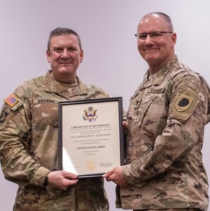 Brig. Gen. Lenny Williams, Assistant Adjutant General – Army, and Commander of the Illinois Army National Guard, presents Col. Randy Edwards, former Chief of Staff, Illinois Army National Guard, with a certificate of retirement during a ceremony March 11 at the Illinois Military Academy, Camp Lincoln, Springfield. Edwards served more than 32 years in the Illinois Army National Guard.