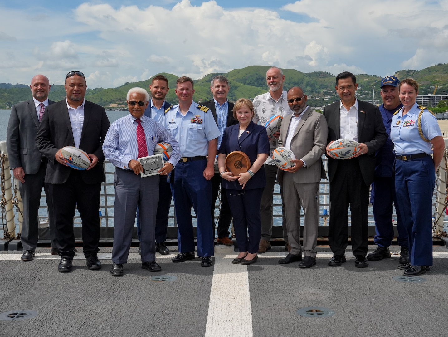 International partners from Papua New Guinea, the Solomon Islands, Indonesia, New Zealand, the United Nations, the European Union and the United States, stand on the flight deck of the Coast Guard Cutter Midgett (WMSL 757) in Port Moresby, Papua New Guinea Mar. 6, 2025. The Coast Guard supports deepening and expanding its relationship with Pacific Islands nations. The United States and Papua New Guinea share a relationship that is based on trust and mutual interests, with our long history of defense partnerships, commercial links, and people-to-people ties. (U.S. Coast Guard photo by Petty Officer 3rd Class Jennifer Nilson)