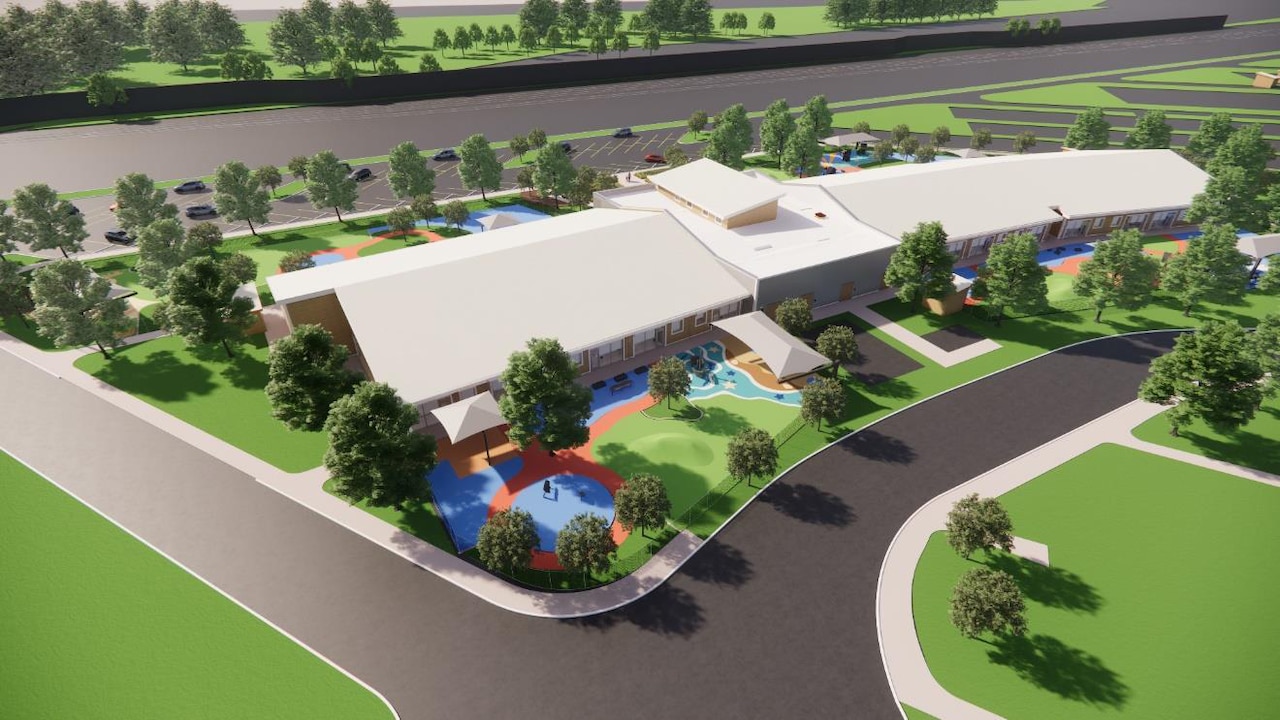 3D bird's-eye view of a building surrounded by landscaping and driveways.