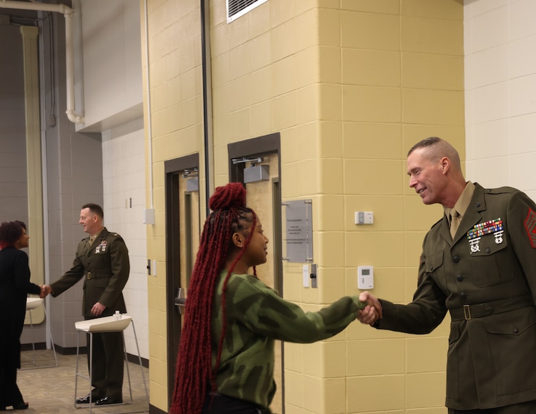 Sgt. Maj. Frank B. Kammer, sergeant major, Marine Corps Logistics Base Albany, alongside Col. Scott A. Clippinger, chief of staff, Marine Corps Logistics Command, joined other community leaders for the ninth annual handshake competition at Commodore Conyers College and Career Academy, March 12.