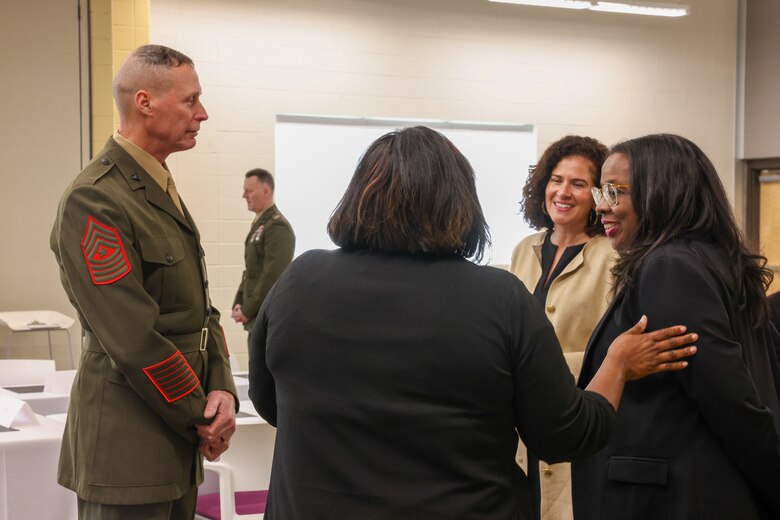 Sgt. Maj. Frank B. Kammer, sergeant major, Marine Corps Logistics Base Albany, alongside Col. Scott A. Clippinger, chief of staff, Marine Corps Logistics Command, joined other community leaders for the ninth annual handshake competition at Commodore Conyers College and Career Academy, March 12.