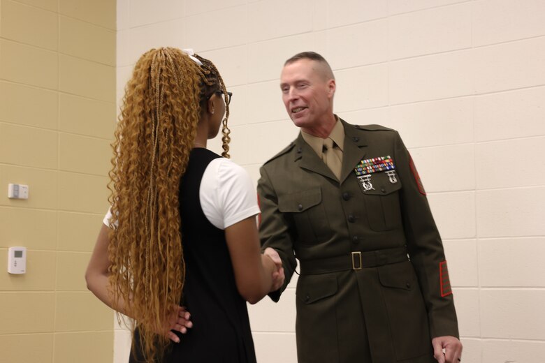 Sgt. Maj. Frank B. Kammer, sergeant major, Marine Corps Logistics Base Albany, alongside Col. Scott A. Clippinger, chief of staff, Marine Corps Logistics Command, joined other community leaders for the ninth annual handshake competition at Commodore Conyers College and Career Academy, March 12.