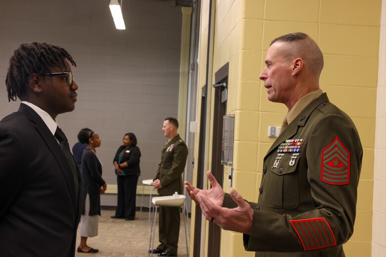 Sgt. Maj. Frank B. Kammer, sergeant major, Marine Corps Logistics Base Albany, alongside Col. Scott A. Clippinger, chief of staff, Marine Corps Logistics Command, joined other community leaders for the ninth annual handshake competition at Commodore Conyers College and Career Academy, March 12.