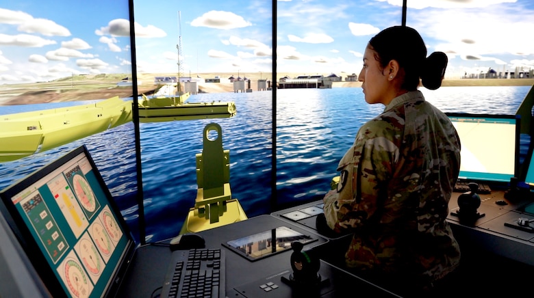 Army Specialist Dayanna Guapisaca navigates a virtual bridge erector boat through a simulation.