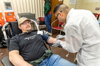 Staff Sgt. Yoseph Roman, medic, Company C, Madigan Army Medical Center, collects blood from Patrick McIlhaga, electronics instructor, Shop 67, Electronics Technicians, March 5, 2025, during the monthly Blood Drive at Puget Sound Naval Shipyard & Intermediate Maintenance Facility in Bremerton, Washington. (U.S. Navy photo by Ben Hutto)
