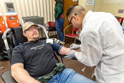 Staff Sgt. Yoseph Roman, medic, Company C, Madigan Army Medical Center, collects blood from Patrick McIlhaga, electronics instructor, Shop 67, Electronics Technicians, March 5, 2025, during the monthly Blood Drive at Puget Sound Naval Shipyard & Intermediate Maintenance Facility in Bremerton, Washington. (U.S. Navy photo by Ben Hutto)