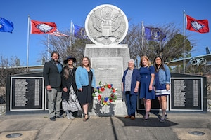 Family members pose in front of the High Flight Memorial during a remembrance ceremony at Little Rock Air Force Base, Arkansas, March 12, 2025. The 314th Airlift Wing hosted the ceremony to commemorate the 40th anniversary of a tragic C-130E Hercules accident which took the lives of six Airmen.