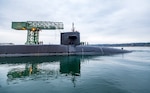 USS Ohio (SSGN 726) passes the Hammerhead Crane as the nuclear-powered guided-missile submarine departs from Pier 5, at Puget Sound Naval Shipyard & Intermediate Maintenance Facility in Bremerton, Washington, Dec. 19, 2024. Ohio returned to the fleet after completing a three-year Major Maintenance Period availability at PSNS & IMF (U.S. Navy photo by Wendy Hallmark)