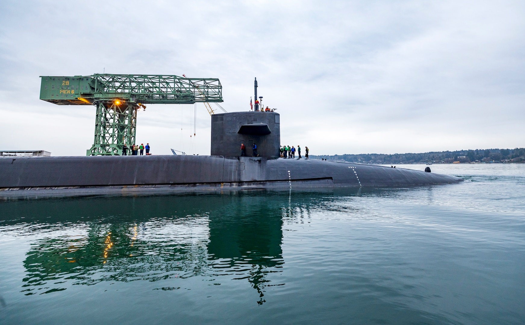 USS Ohio (SSGN 726) passes the Hammerhead Crane as the nuclear-powered guided-missile submarine departs from Pier 5, at Puget Sound Naval Shipyard & Intermediate Maintenance Facility in Bremerton, Washington, Dec. 19, 2024. Ohio returned to the fleet after completing a three-year Major Maintenance Period availability at PSNS & IMF (U.S. Navy photo by Wendy Hallmark)