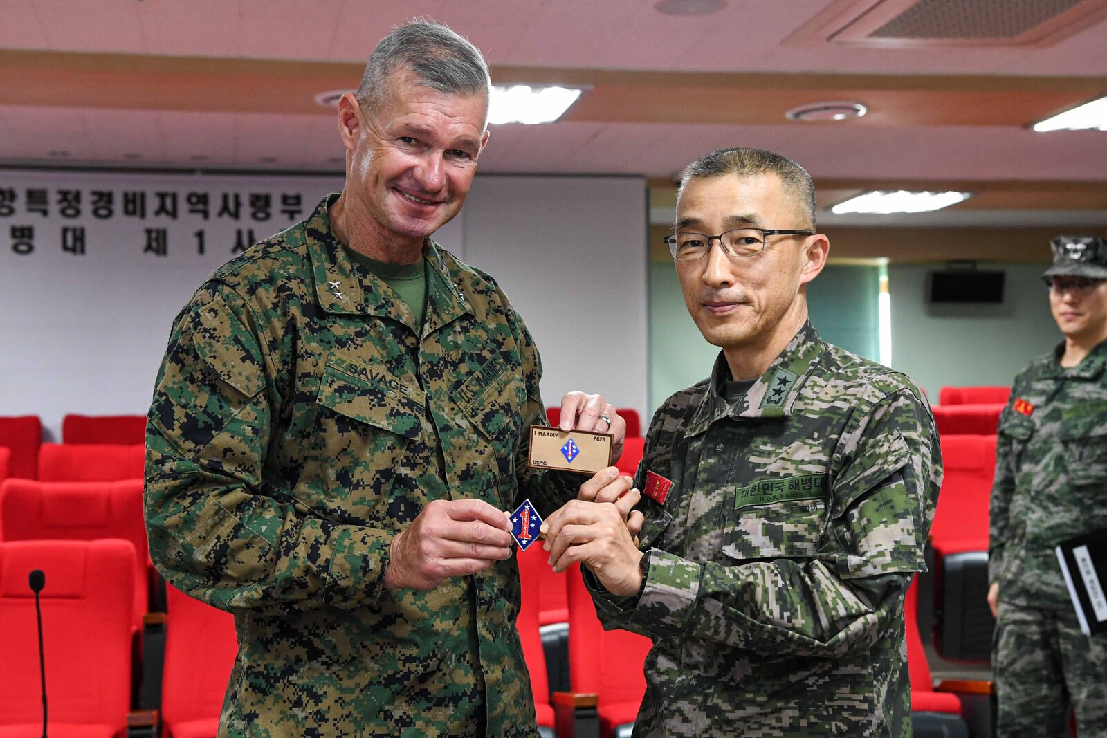 U.S. Marine Corps Maj. Gen. Thomas B. Savage, left, the commanding general of 1st Marine Division, gifts a 1st MARDIV coin and patch to Republic of Korea Marine Corps Maj. Gen. Lee Ho Jong, the commanding general of 1st Marine Division, ROK Marine Corps, during a meeting in Pohang, South Korea, March 7, 2025. Freedom Shield is an exercise that provides iterative opportunities for Republic of Korea Marine Corps and U.S. Marine Corps units to train together, improving their combined capabilities to deter threats and maintain peace on the Korean Peninsula. (Courtesy photo from Republic of Korea Marine Corps)