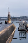 Crew members stand topside as USS Ohio (SSGN 726) prepares to depart from Pier 5 at Puget Sound Naval Shipyard & Intermediate Maintenance Facility in Bremerton, Washington, Dec 19, 2025, as it transitioned to its final stage of testing and crew certification. (U.S. Navy photo by Wendy Hallmark)