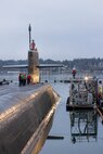 Crew members stand topside as USS Ohio (SSGN 726) prepares to depart from Pier 5 at Puget Sound Naval Shipyard & Intermediate Maintenance Facility in Bremerton, Washington, Dec 19, 2025, as it transitioned to its final stage of testing and crew certification. (U.S. Navy photo by Wendy Hallmark)