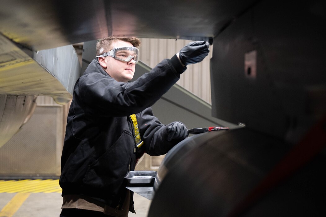 U.S. Air Force Senior Airman Therron Rude, 18th Fighter Generation Squadron crew chief, inspects the connection points for a flaperon on an F-16 Fighting Falcon at Eielson Air Force Base, Alaska, March 4, 2025.