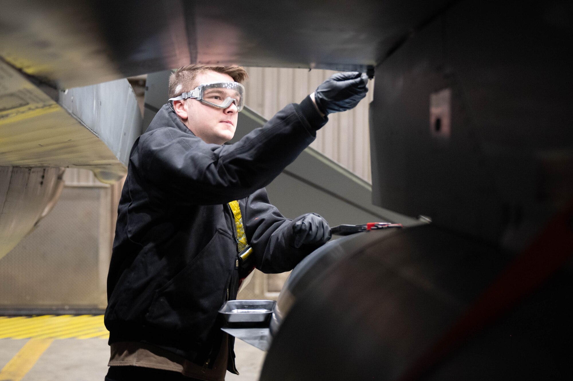U.S. Air Force Senior Airman Therron Rude, 18th Fighter Generation Squadron crew chief, inspects the connection points for a flaperon on an F-16 Fighting Falcon at Eielson Air Force Base, Alaska, March 4, 2025.