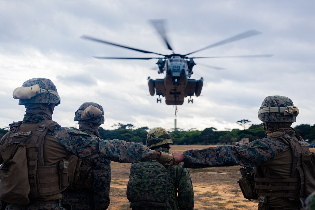 U.S. Marines and U.S. Navy corpsmen with Combat Logistics Battalion 31, 31st Marine Expeditionary Unit, observe a notional lift during an external lift exercise in support of Iron Fist 25, at Camp Hansen, Okinawa, Japan, Feb. 22, 2025. Iron Fist is an annual bilateral exercise designed to increase interoperability and strengthen the relationships between the U.S Marine Corps, U.S. Navy and Japan Ground Self-Defense Force. The 31st Marine Expeditionary Unit, the Marine Corps’ only continuously forward deployed MEU, provides a flexible and lethal force, ready to perform a wide range of military operations as the premier crisis response force in the Indo-Pacific region. Wharton is a native of Texas. (U.S. Marine Corps photo by Lance Cpl. Raul Sotovilla)