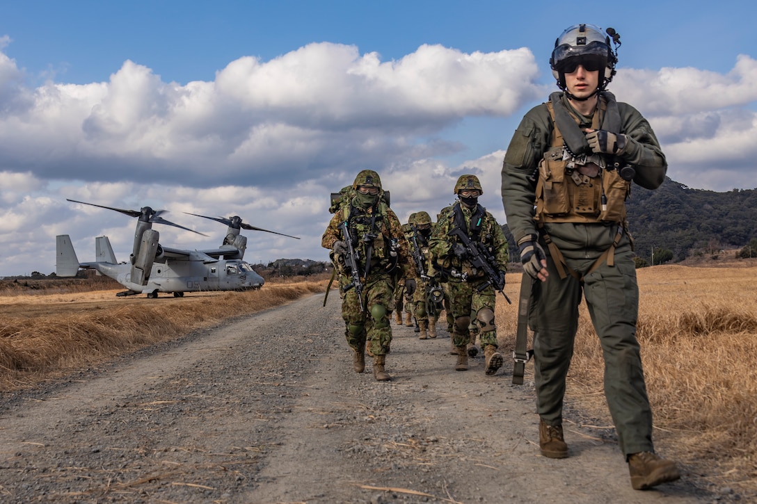 U.S. Marine Corps Staff Sgt. Quentin Kennell, a tiltrotor crew chief, MV-22, with Marine Medium Tiltrotor Squadron (VMM) 262 (Rein.), 31st Marine Expeditionary Unit, right, and Japan Ground Self-Defense Force members with 1st Amphibious Rapid Deployment Regiment, prepare to embark U.S. Marine Corps MV-22B Ospreys assigned to VMM-262 (Rein.), during a bilateral insert exercise in support of Iron Fist 25, at JGSDF Camp Ainoura, Sasebo, Nagasaki, Japan, Feb. 23, 2025. Iron Fist is an annual bilateral exercise designed to increase interoperability and strengthen the relationships between the U.S. Marine Corps, U.S. Navy and Japan Ground Self-Defense Force. The 31st MEU, the Marine Corps’ only continuously forward deployed MEU, provides a flexible and lethal force, ready to perform a wide range of military operations as the premiere crisis response force in the Indo-Pacific region. Kennell is a native of California. (U.S. Marine Corps photo by Sgt. Tyler Andrews)